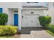 Front entrance with blue door and white garage door at 1551 Flange Dr, Davenport, FL 33896