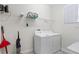 Bright laundry room with washer, dryer, and shelving at 1551 Flange Dr, Davenport, FL 33896