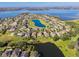 Aerial view of a lakefront community with luxury homes and lush landscaping at 15944 Citrus Knoll Dr, Winter Garden, FL 34787