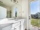 Bright bathroom with white vanity and exterior access at 15944 Citrus Knoll Dr, Winter Garden, FL 34787