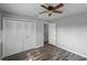 Well-lit bedroom with wood-look floors, ceiling fan and large closet at 1640 Templewood Ave, Deltona, FL 32725