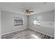 Bedroom with wood-look flooring, ceiling fan and ample natural light at 1640 Templewood Ave, Deltona, FL 32725