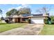 Front view of a single-story house with a garage and a spacious lawn at 1640 Templewood Ave, Deltona, FL 32725