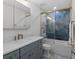 Modern bathroom with a blue patterned shower and gray vanity at 1812 Turnberry Ter, Orlando, FL 32804