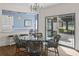 Bright dining area with glass table, wicker chairs, and view of the backyard at 1812 Turnberry Ter, Orlando, FL 32804