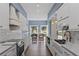 Long kitchen with white cabinets, marble counters, and a farmhouse sink at 1812 Turnberry Ter, Orlando, FL 32804