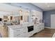 Modern kitchen with white cabinets, marble countertops, and a built-in wine cooler at 1812 Turnberry Ter, Orlando, FL 32804