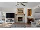 Living room with fireplace, hardwood floors, and large TV at 1812 Turnberry Ter, Orlando, FL 32804