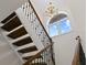 Stunning staircase with wrought iron railing and chandelier at 1812 Turnberry Ter, Orlando, FL 32804