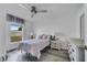 Bright bedroom with ceiling fan, side tables and wood-look floors at 1834 Roper Rd, St Cloud, FL 34771