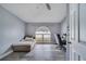 Bright bedroom with natural light from a large arched window and wood-look flooring at 1834 Roper Rd, St Cloud, FL 34771