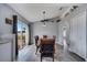 Charming dining room area with wood table, blue upholstered chairs, sliding glass doors and wood-look flooring at 1834 Roper Rd, St Cloud, FL 34771