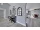 Bright living area featuring arched windows and wood-look flooring that connects to the dining and kitchen area at 1834 Roper Rd, St Cloud, FL 34771