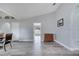 Open floor plan showcases the dining area and entry to the front of the home with sleek wood-look flooring at 1834 Roper Rd, St Cloud, FL 34771