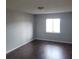 Simple bedroom with dark wood floors and light walls at 1928 Conway Rd # 23, Orlando, FL 32812