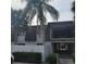 Condo building exterior with palm trees and white fence at 1928 Conway Rd # 23, Orlando, FL 32812