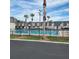 Community pool with palm trees and surrounding buildings at 1928 Conway Rd # 23, Orlando, FL 32812