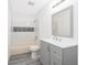 Clean bathroom, featuring gray floor tile and a gray vanity with a white countertop at 2006 Key Lime St, Ocoee, FL 34761