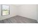 Well-lit bedroom featuring gray vinyl plank flooring and a window with blinds at 2006 Key Lime St, Ocoee, FL 34761