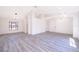 Bright and airy living room with gray vinyl plank flooring and large windows at 2006 Key Lime St, Ocoee, FL 34761