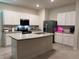 Modern kitchen featuring white cabinets, stainless steel appliances, and an island at 2252 Tay Wes Dr, St Cloud, FL 34771