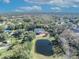 Aerial view showing the house, pond, and surrounding neighborhood at 2323 Tuskawilla Rd, Oviedo, FL 32765