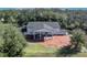 Aerial view of a large house with a pond and surrounding landscape at 2323 Tuskawilla Rd, Oviedo, FL 32765