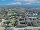 Aerial view of house and pond; large lot with mature trees and nearby lake at 2323 Tuskawilla Rd, Oviedo, FL 32765