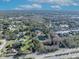 Aerial view of house and pond; large lot with mature trees and nearby lake at 2323 Tuskawilla Rd, Oviedo, FL 32765