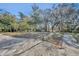 Landscaped backyard with a curved concrete path and brick accents at 2323 Tuskawilla Rd, Oviedo, FL 32765