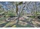 Landscaped backyard with a tranquil waterway and lush trees at 2323 Tuskawilla Rd, Oviedo, FL 32765