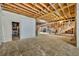 Unfinished basement with exposed beams, framing, and concrete flooring at 2323 Tuskawilla Rd, Oviedo, FL 32765