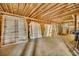 Unfinished basement area with exposed wood framing and stacks of doors at 2323 Tuskawilla Rd, Oviedo, FL 32765