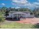 White house with a portico and brick driveway at 2323 Tuskawilla Rd, Oviedo, FL 32765