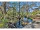 Serene waterfront view with lush trees and tranquil water at 2323 Tuskawilla Rd, Oviedo, FL 32765