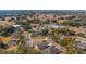 Aerial view showing a quiet residential neighborhood with houses and green spaces at 24414 Woodhill Ct, Sorrento, FL 32776