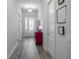 Inviting entryway with red accent cabinet and hardwood floors at 24414 Woodhill Ct, Sorrento, FL 32776