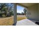 Covered patio with view of the treelined street at 24414 Woodhill Ct, Sorrento, FL 32776