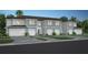 Three-unit townhome building, two-car garage, light gray siding, and landscaping at 2534 Winsome Way, Davenport, FL 33896