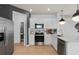 Modern kitchen with white cabinets, stainless steel appliances, and quartz countertops at 2534 Winsome Way, Davenport, FL 33896