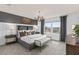 Spacious main bedroom with gray upholstered bed, large windows, and accent wall at 2534 Winsome Way, Davenport, FL 33896