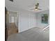 Bedroom with gray carpet, ceiling fan, and view of the pool at 270 Debary Dr, Debary, FL 32713