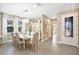 Elegant dining room featuring a glass-top table and chandelier at 305 Silver Maple Rd, Groveland, FL 34736