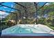 Enjoy this hot tub under the screened patio at 305 Silver Maple Rd, Groveland, FL 34736