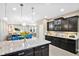 Large kitchen island with granite countertop and dark wood cabinetry at 305 Silver Maple Rd, Groveland, FL 34736