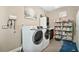 Laundry room with washer, dryer, and shelving at 305 Silver Maple Rd, Groveland, FL 34736