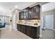 Built-in wet bar with dark cabinetry and granite countertop at 305 Silver Maple Rd, Groveland, FL 34736