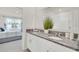 Double vanity bathroom with granite countertop and a view of the bedroom at 316 Pelham Park Dr, Deland, FL 32720