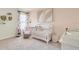 Charming Bedroom featuring a crib, armchair, and changing station at 316 Pelham Park Dr, Deland, FL 32720