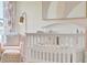 Bedroom with crib, armchair, and soft color palette at 316 Pelham Park Dr, Deland, FL 32720